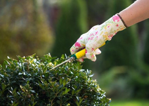 Crew sorting garden waste into labeled bays at a green depot